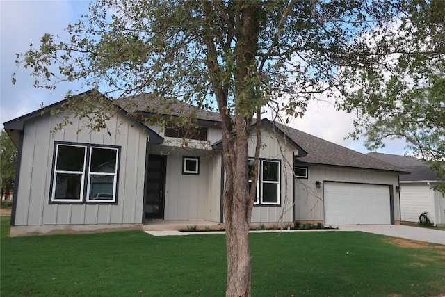 119 Waimanalo Dr, Bastrop, TX 78602 - ranch-style home featuring an attached garage, concrete driveway, a front yard, roof with shingles, and board and batten siding