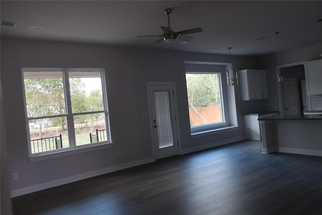 119 Waimanalo Dr, Bastrop, TX 78602 - unfurnished living room with dark wood finished floors and a ceiling fan