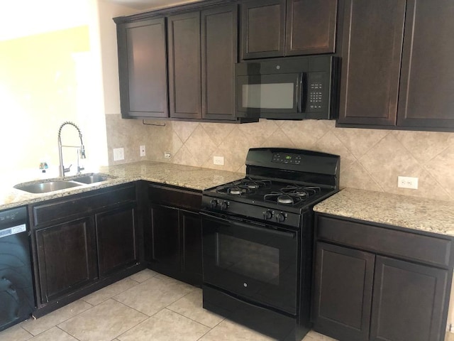3505 Breckenridge Dr, Austin, TX 78744 - kitchen with black appliances, light stone counters, tasteful backsplash, and light tile patterned floors