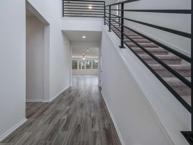 13519 Feldspar Dr, Austin, TX 78729 - corridor featuring wood finished floors, a high ceiling, and stairs