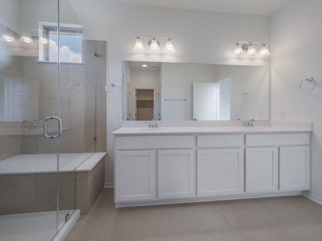 13519 Feldspar Dr, Austin, TX 78729 - full bath with a shower stall, double vanity, and tile patterned floors