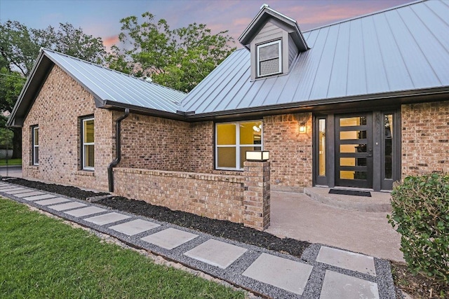 503 Elm St, Bastrop, TX 78602 - view of front of property with brick siding, a standing seam roof, and a metal roof