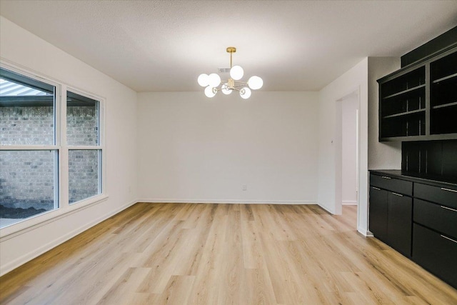 503 Elm St, Bastrop, TX 78602 - unfurnished dining area featuring a chandelier and light wood-style flooring