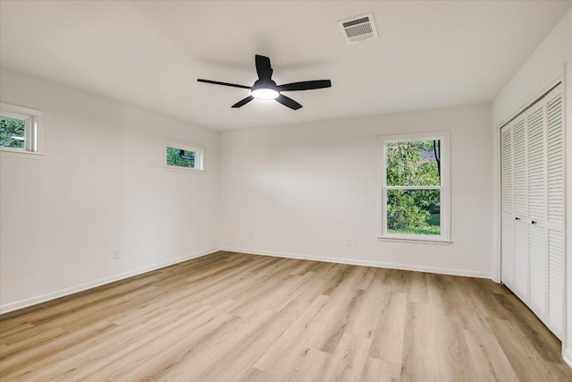 503 Elm St, Bastrop, TX 78602 - unfurnished bedroom featuring light wood-type flooring, a closet, and ceiling fan
