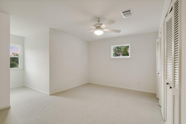 503 Elm St, Bastrop, TX 78602 - unfurnished bedroom with carpet floors, multiple windows, and a closet