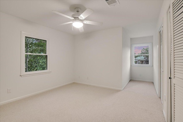 503 Elm St, Bastrop, TX 78602 - unfurnished bedroom featuring multiple windows, light colored carpet, and a closet