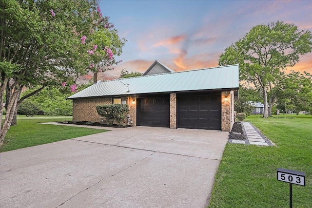 503 Elm St, Bastrop, TX 78602 - view of side of home featuring a garage, a lawn, concrete driveway, and brick siding