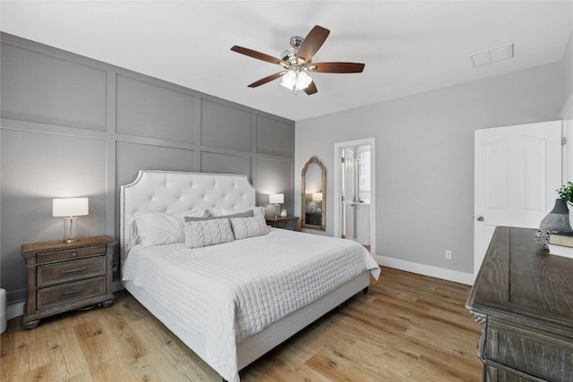 3431 Ranch Park Trl, Round Rock, TX 78681 - bedroom featuring a decorative wall, light wood finished floors, ceiling fan, and ensuite bath