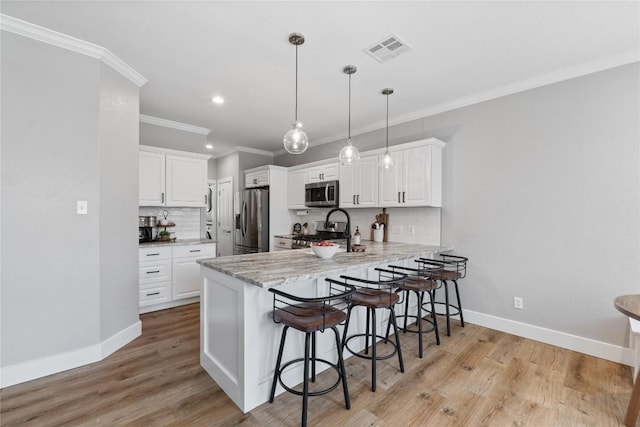 3431 Ranch Park Trl, Round Rock, TX 78681 - kitchen featuring appliances with stainless steel finishes, a peninsula, a breakfast bar, backsplash, and ornamental molding