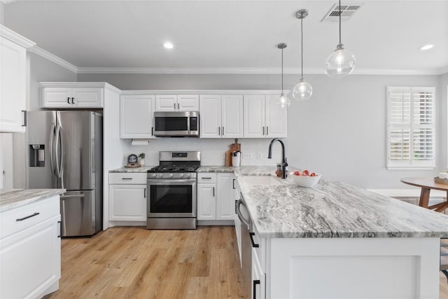 3431 Ranch Park Trl, Round Rock, TX 78681 - kitchen featuring appliances with stainless steel finishes, a peninsula, crown molding, white cabinetry, and pendant lighting