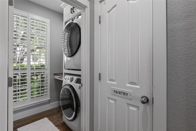 3431 Ranch Park Trl, Round Rock, TX 78681 - laundry area with stacked washer / dryer, dark wood finished floors, and a textured wall