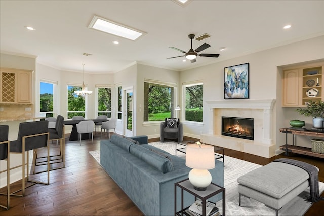 138 Top O The Lake Dr, Lakeway, TX 78734 - living room featuring a high end fireplace, a chandelier, recessed lighting, wood finished floors, and ceiling fan