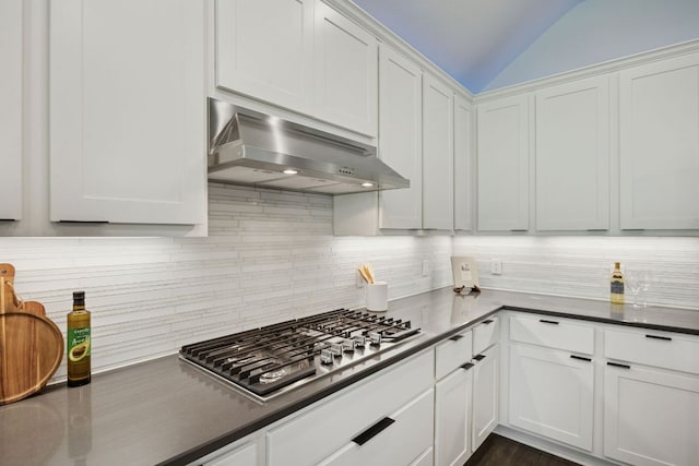 1816 Arapaho Mountain Pass, Leander, TX 78641 - kitchen with stainless steel gas cooktop, range hood, tasteful backsplash, lofted ceiling, and white cabinetry