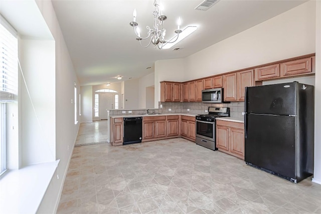 1504 Morning Mist Ln, Pflugerville, TX 78660 - kitchen with black appliances, a chandelier, light countertops, tasteful backsplash, and a peninsula