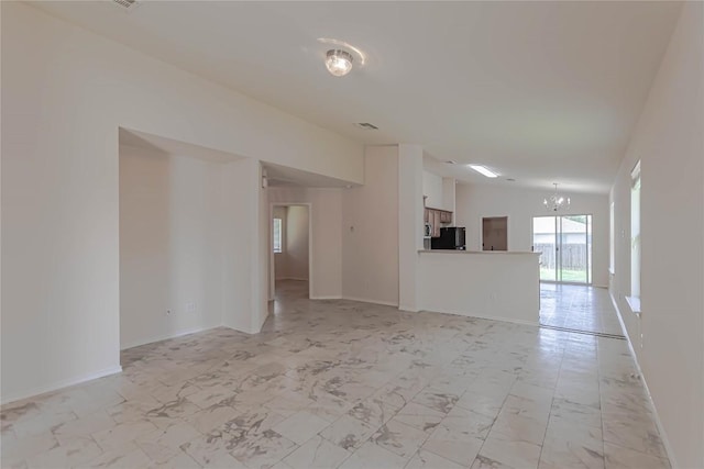 1504 Morning Mist Ln, Pflugerville, TX 78660 - unfurnished living room featuring a chandelier, light marble finish floors, and lofted ceiling
