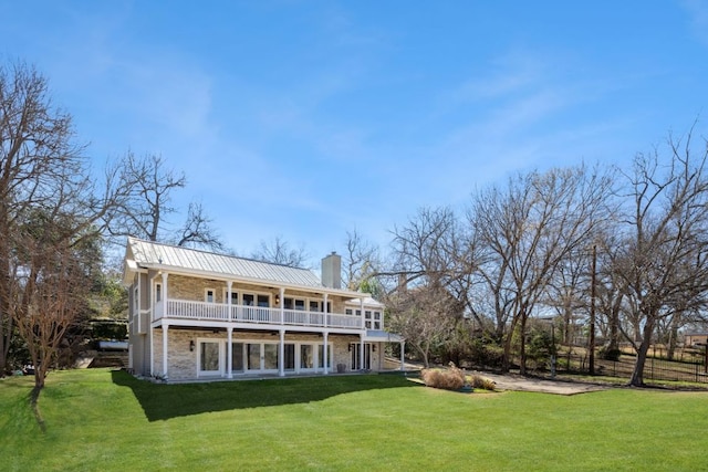 10810 River Terrace Cir, Austin, TX 78733 - rear view of house with a yard, a chimney, a metal roof, and a balcony