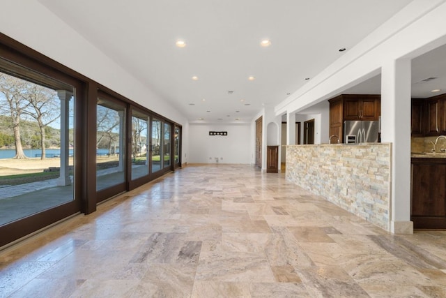10810 River Terrace Cir, Austin, TX 78733 - unfurnished living room with recessed lighting and light stone finish floors