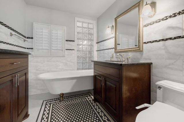 10810 River Terrace Cir, Austin, TX 78733 - bathroom featuring tile walls, vanity, and a freestanding bath