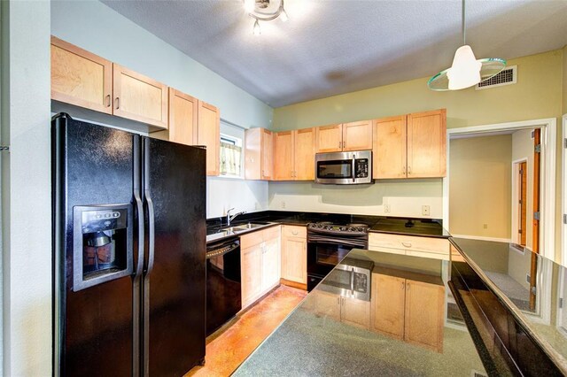 711 W 26th St Unit 504, Austin, TX 78705 - kitchen featuring black appliances, light brown cabinetry, dark countertops, and hanging light fixtures