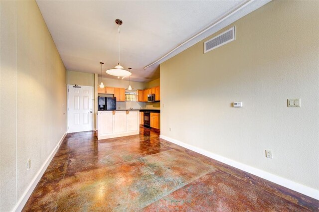711 W 26th St Unit 504, Austin, TX 78705 - unfurnished living room with finished concrete flooring and baseboards