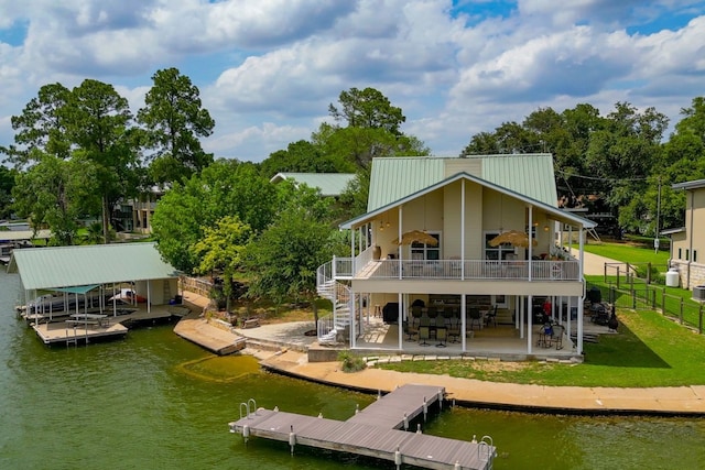 134 Glen Oaks Dr, Sunrise Beach, TX 78643 - rear view of house featuring stairs, a patio area, a deck with water view, a metal roof, and boat lift