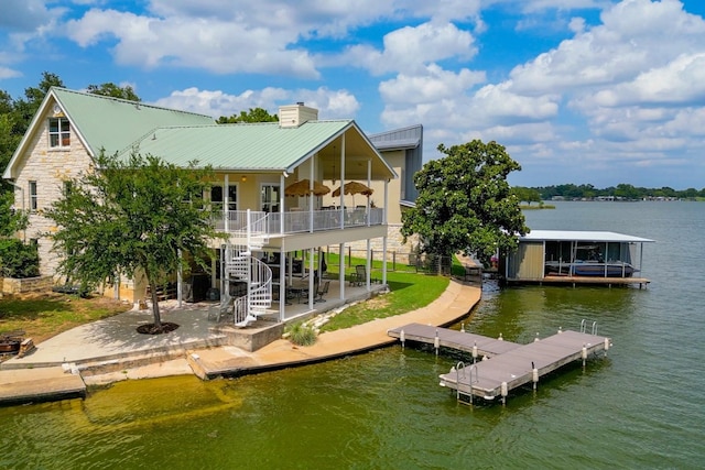 134 Glen Oaks Dr, Sunrise Beach, TX 78643 - rear view of house with a water view, stairway, a chimney, a metal roof, and stone siding