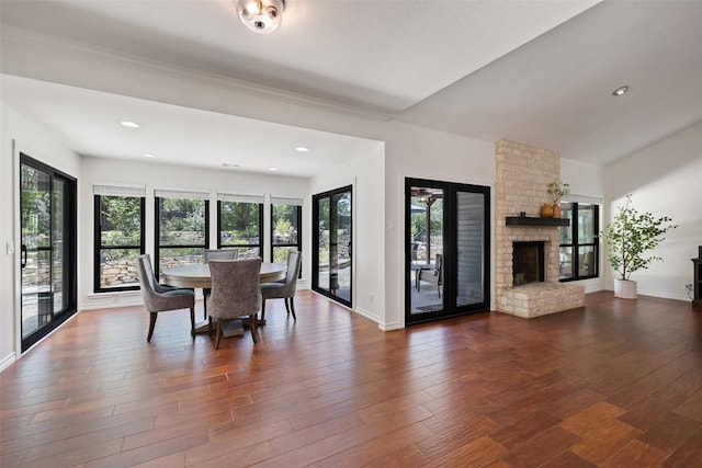 103 Schooner Dr, Lakeway, TX 78738 - dining room featuring a stone fireplace, dark wood-type flooring, and recessed lighting