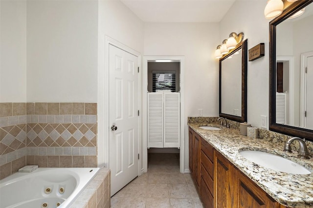 103 Schooner Dr, Lakeway, TX 78738 - bathroom featuring double vanity, a whirlpool tub, tile patterned floors, and a closet