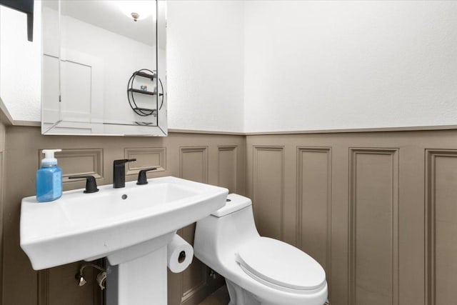 5304 China Garden Dr, Austin, TX 78730 - half bathroom with wainscoting and a decorative wall