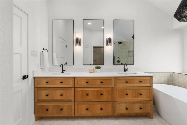 5304 China Garden Dr, Austin, TX 78730 - bathroom with a tile shower, double vanity, and a freestanding tub