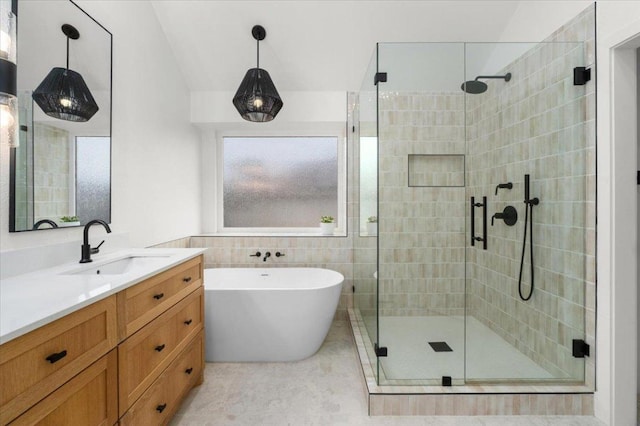 5304 China Garden Dr, Austin, TX 78730 - bathroom with a shower stall, a soaking tub, vanity, and tile walls