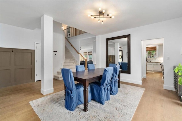 5304 China Garden Dr, Austin, TX 78730 - dining room with stairs, light wood-style floors, and a chandelier