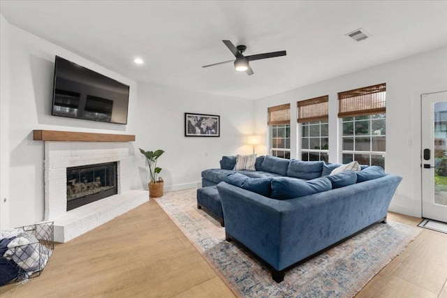 5304 China Garden Dr, Austin, TX 78730 - living room with a ceiling fan, wood finished floors, a fireplace, plenty of natural light, and recessed lighting