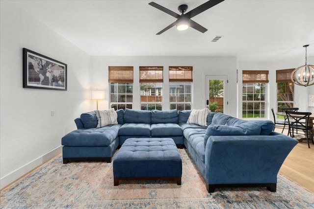 5304 China Garden Dr, Austin, TX 78730 - living room with a chandelier, a ceiling fan, and wood finished floors