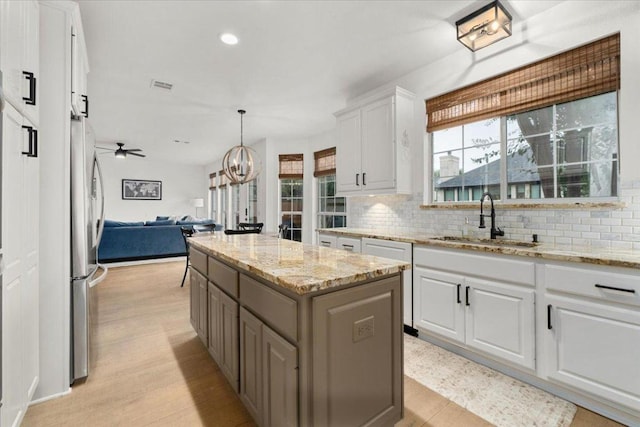 5304 China Garden Dr, Austin, TX 78730 - kitchen featuring open floor plan, freestanding refrigerator, tasteful backsplash, healthy amount of natural light, and recessed lighting