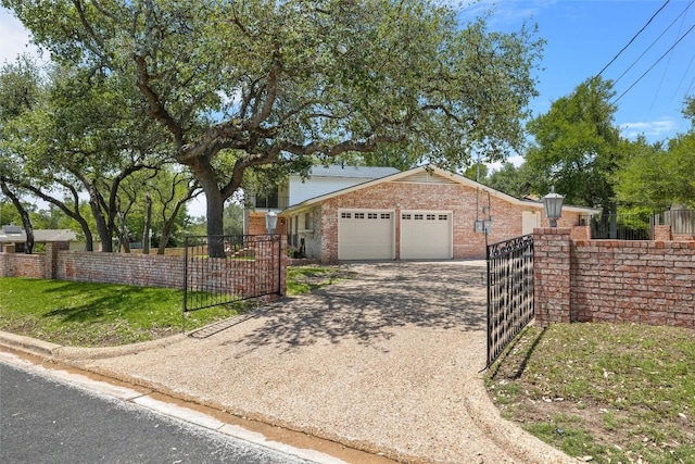 7606 Mesa Dr, Austin, TX 78731 - view of front of home featuring an attached garage, a gate, a fenced front yard, driveway, and brick siding