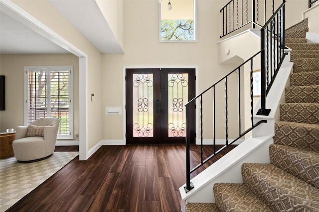 7606 Mesa Dr, Austin, TX 78731 - foyer entrance featuring wood finished floors, stairs, healthy amount of natural light, and a towering ceiling