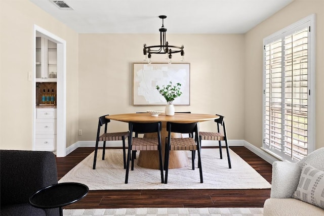 7606 Mesa Dr, Austin, TX 78731 - dining space with dark wood finished floors and a chandelier