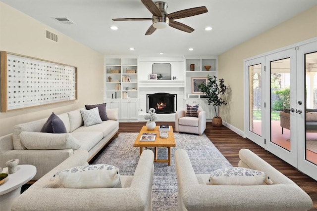7606 Mesa Dr, Austin, TX 78731 - living room with ceiling fan, wood finished floors, recessed lighting, a warm lit fireplace, and french doors