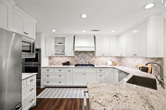 7606 Mesa Dr, Austin, TX 78731 - kitchen featuring stainless steel appliances, custom exhaust hood, white cabinets, light stone counters, and recessed lighting