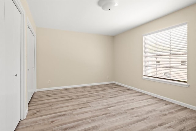 7606 Mesa Dr, Austin, TX 78731 - unfurnished bedroom with a closet and light wood-style floors