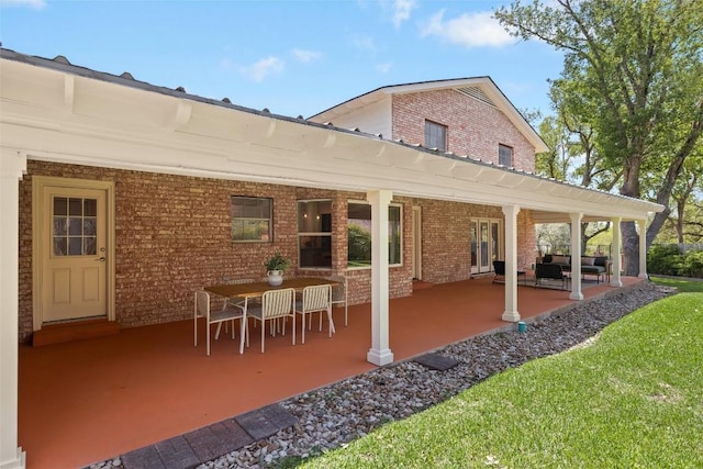 7606 Mesa Dr, Austin, TX 78731 - rear view of property featuring brick siding and a patio