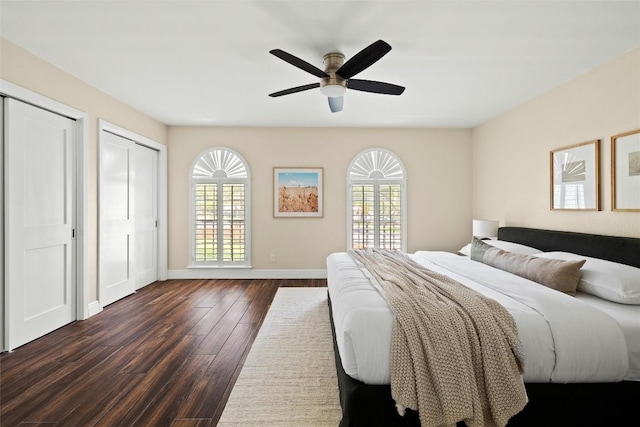 7606 Mesa Dr, Austin, TX 78731 - bedroom featuring dark wood finished floors, two closets, and a ceiling fan
