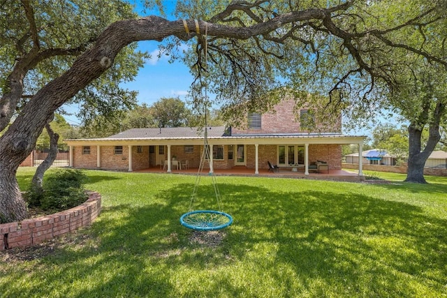 7606 Mesa Dr, Austin, TX 78731 - back of property with french doors, a patio area, and brick siding