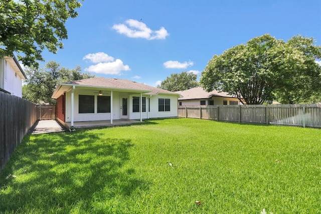 1718 Zydeco Dr, Round Rock, TX 78664 - back of property featuring a ceiling fan, a fenced backyard, and a patio