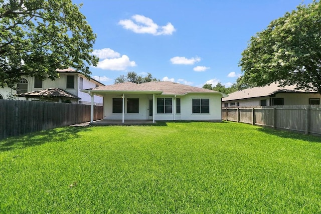 1718 Zydeco Dr, Round Rock, TX 78664 - rear view of house featuring a fenced backyard, a patio, and stucco siding