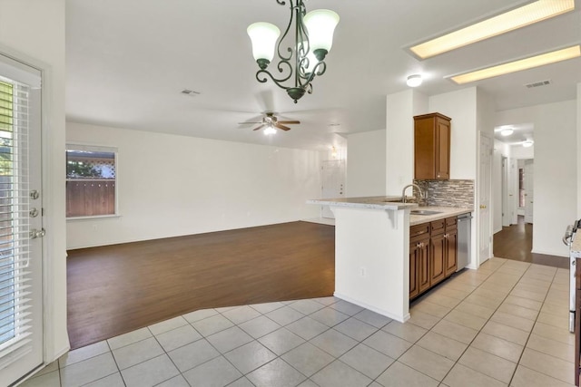 1718 Zydeco Dr, Round Rock, TX 78664 - kitchen with light tile patterned floors, ceiling fan, open floor plan, dishwasher, and tasteful backsplash