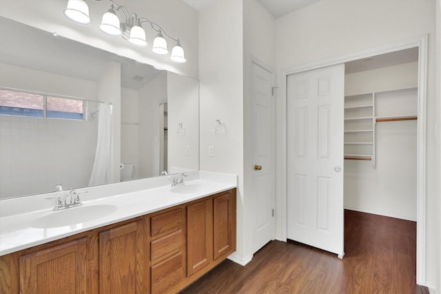 1718 Zydeco Dr, Round Rock, TX 78664 - bathroom with wood finished floors, double vanity, and a shower with shower curtain