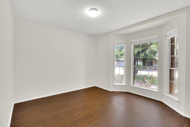 1718 Zydeco Dr, Round Rock, TX 78664 - empty room with dark wood-style flooring and baseboards