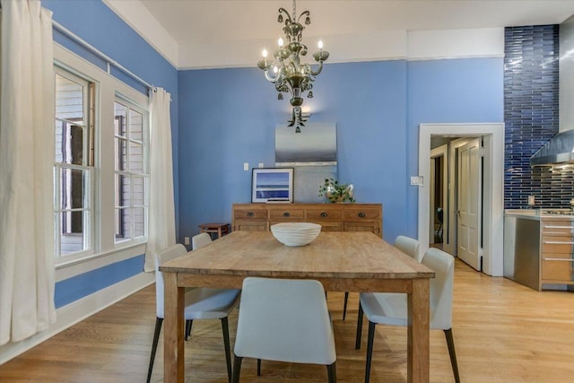 2109 Nickerson St, Austin, TX 78704 - dining room featuring light wood finished floors and a chandelier